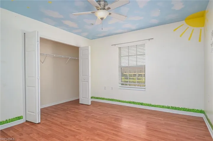 Unfurnished bedroom featuring a closet, ceiling fan, and light hardwood / wood-style flooring