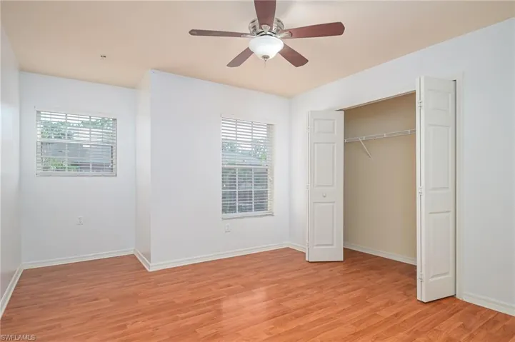 Unfurnished bedroom featuring a closet, ceiling fan, and light wood-type flooring