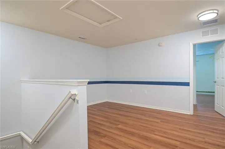 Spare room with wood-type flooring
