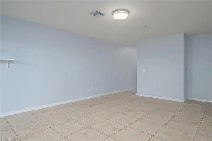 Empty room with light tile floors