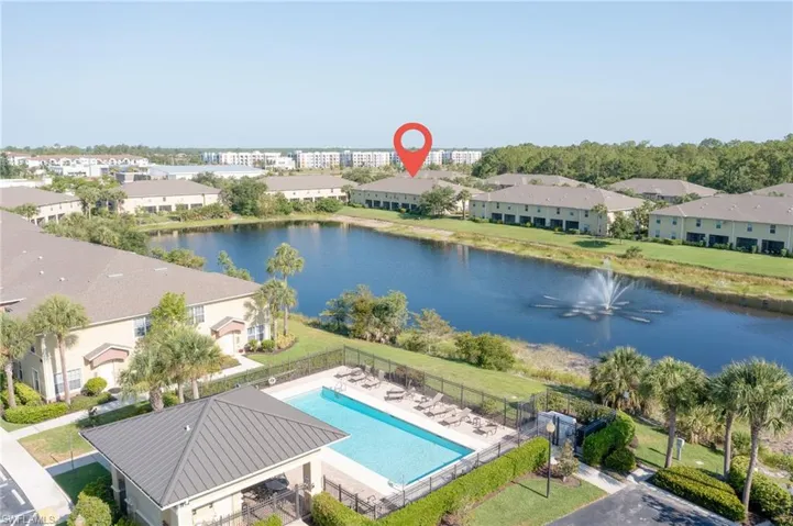 Birds eye view of property with a water view