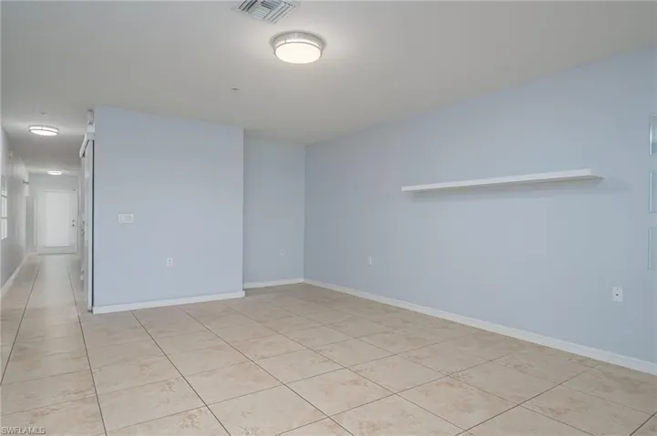 Empty room with light tile floors