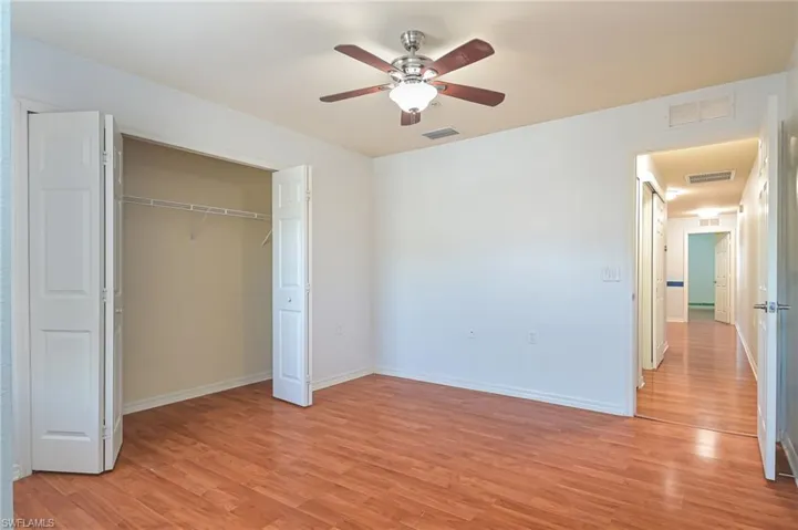 Unfurnished bedroom featuring a closet, ceiling fan, and light hardwood / wood-style floors