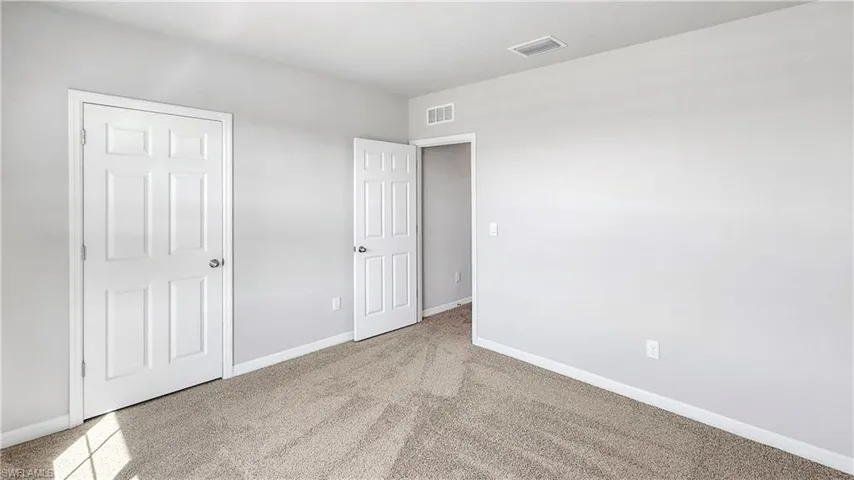 bedroom featuring light carpet