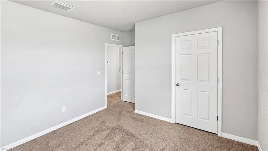 Unfurnished bedroom featuring carpet flooring
