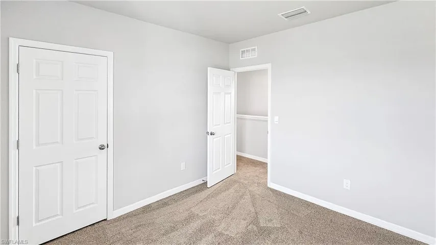 Unfurnished bedroom with carpet floors