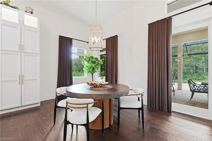 Wood-finish flooring with white built-in cabinetry featuring glass accents
