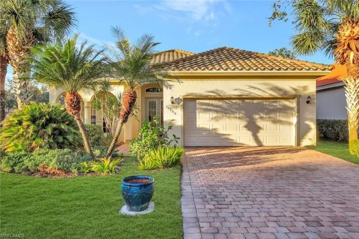 Mediterranean / spanish house with a garage and a front yard