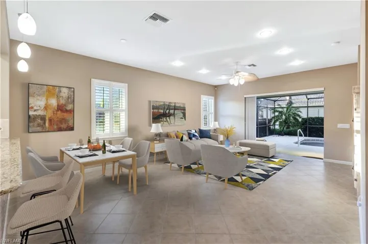 Tiled living room featuring ceiling fan