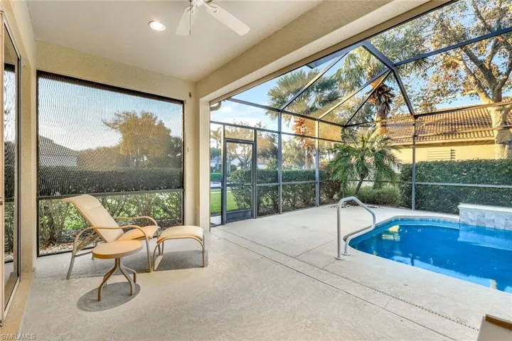 View of swimming pool with a lanai, ceiling fan, and a patio area