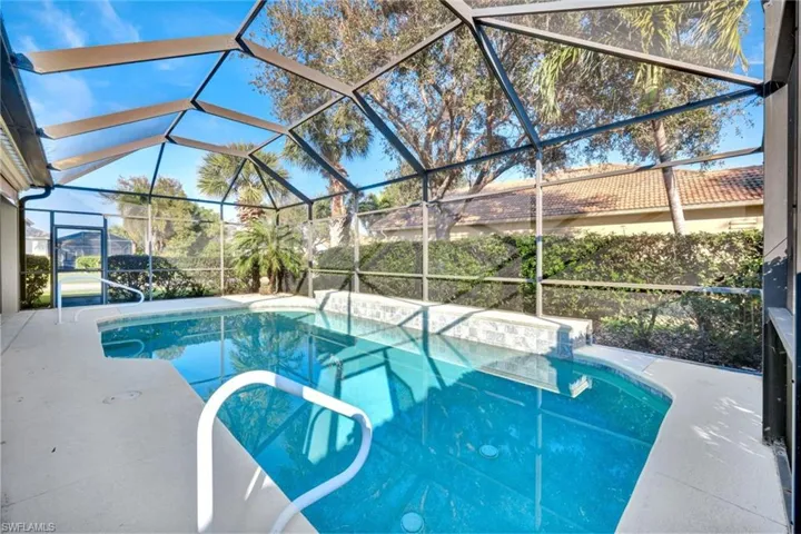 View of swimming pool with a lanai and a patio area