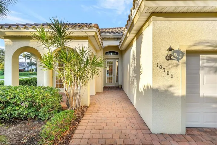 View of exterior entry with a garage