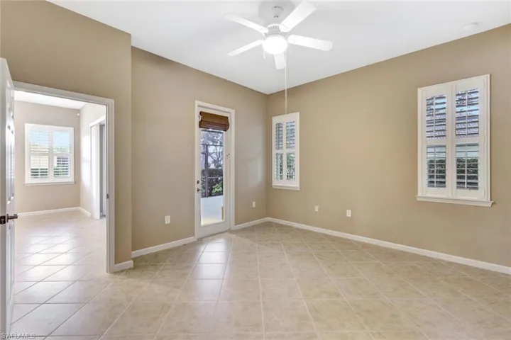 Tiled empty room with ceiling fan