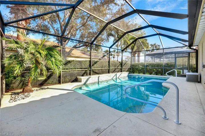 View of swimming pool featuring central AC, a patio area, and glass enclosure