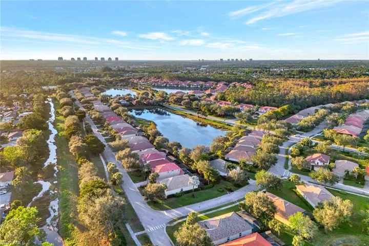 Birds eye view of property with a water view