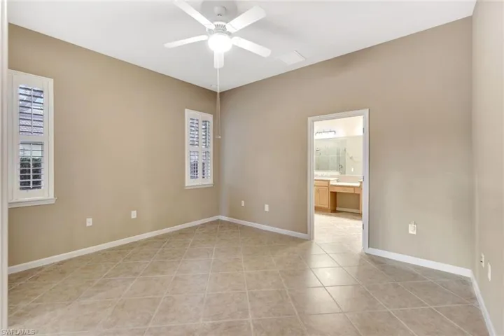 Empty room featuring light tile patterned floors and ceiling fan