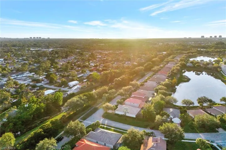 Birds eye view of property with a water view