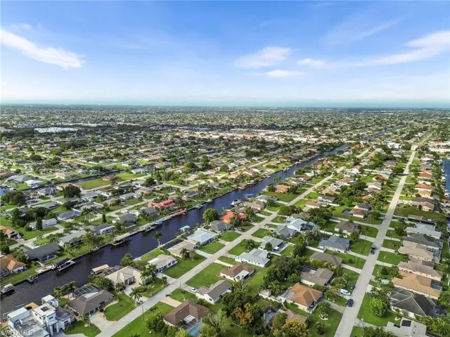 Aerial overview of property's location featuring nearby suburban area and a large body of water