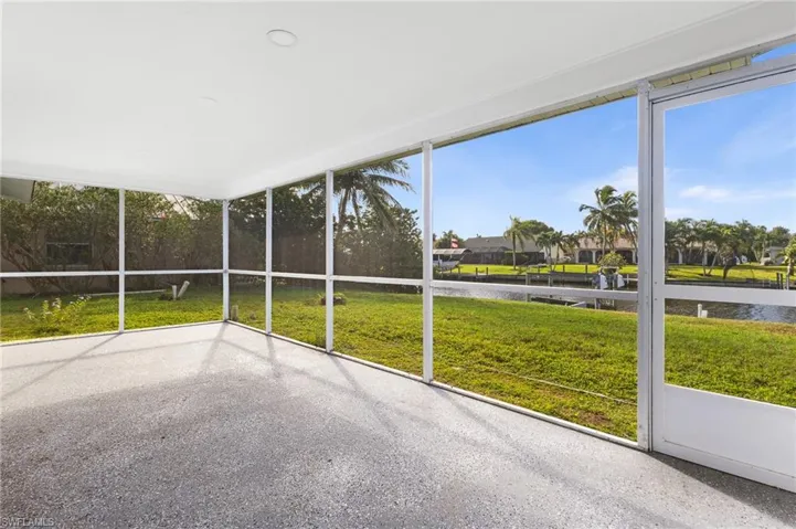 Unfurnished sunroom featuring a water view