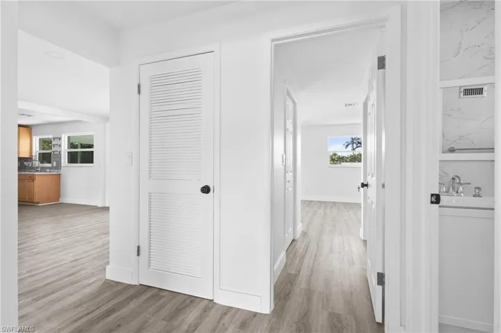 Hall featuring light wood-type flooring and baseboards