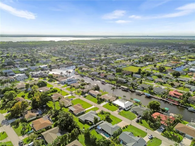 Aerial perspective of suburban area with a large body of water