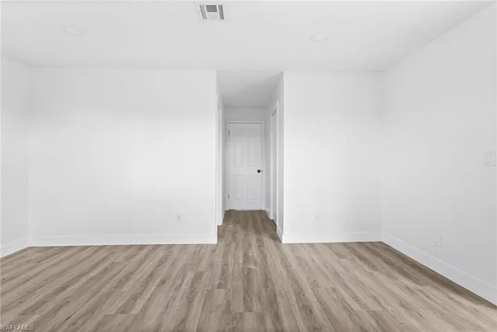 Empty room featuring light wood finished floors and baseboards