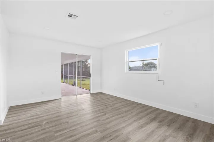 Spare room featuring healthy amount of natural light, light wood-style flooring, and recessed lighting