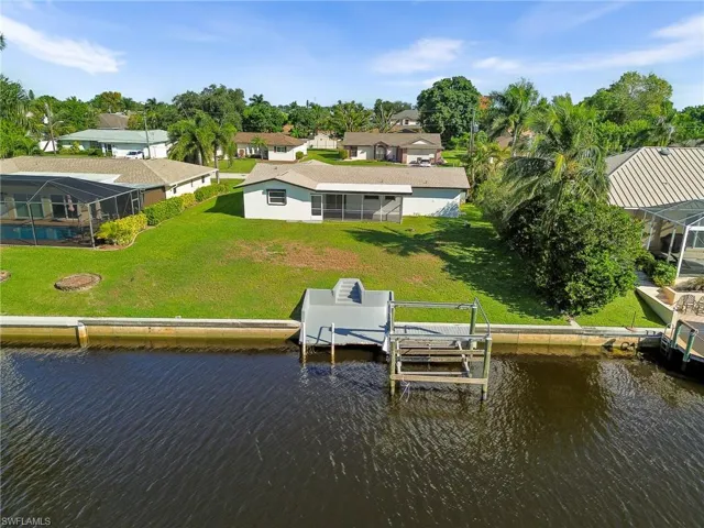 Dock featuring a lanai, a sunroom, and a yard
