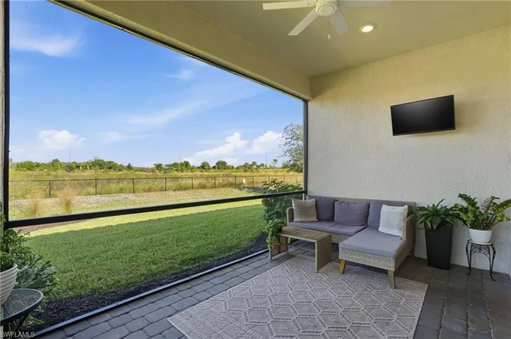 Semi-panoramic screened lanai overlooking private preserve area.