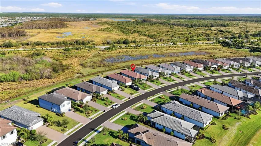 Aerial view of property, surrounding neighborhood, and private preserve view.