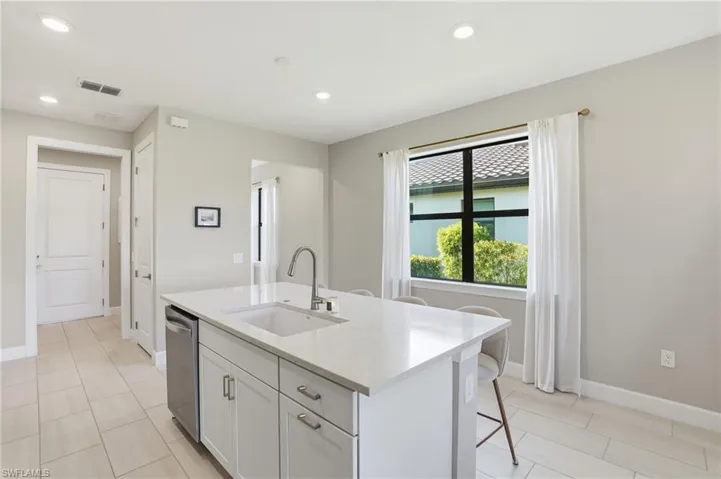 Spacious kitchen island with breakfast bar seating.