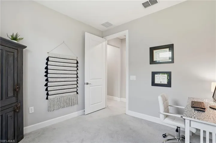 Guest bedroom being utilized as an office space.