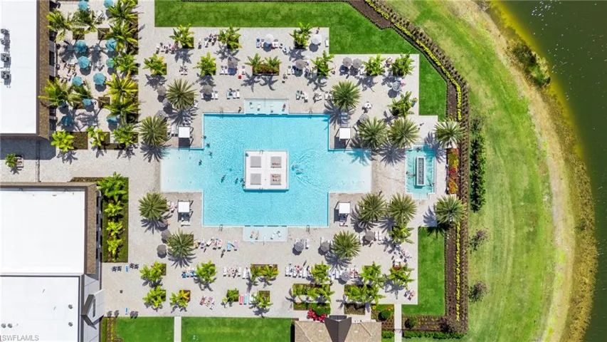 Aerial view of resort-style pool and outdoor restaurant seating.