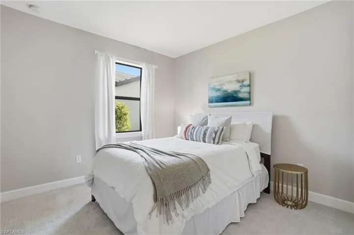 Large guest bedroom with plush carpeted floors.