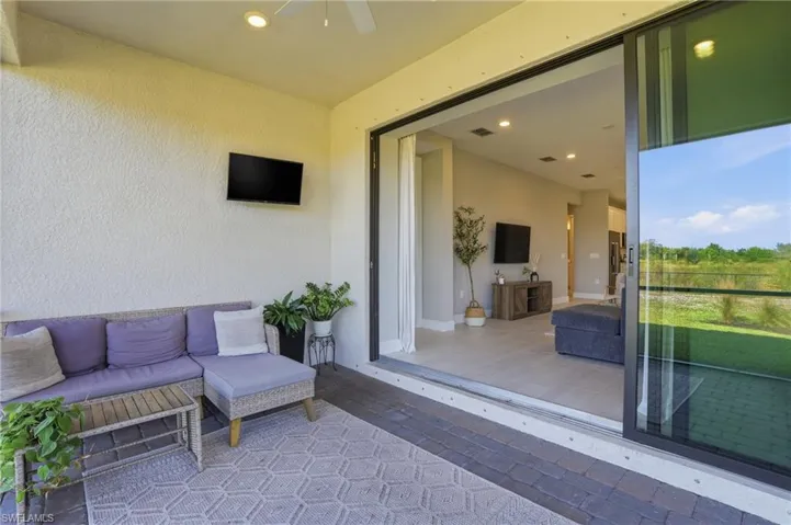 Large panel sliders open up to screened lanai overlooking private preserve area.