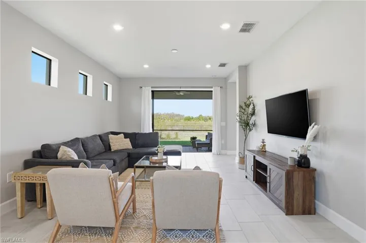 Main living area off kitchen opens up to screened lanai with private preserve view.