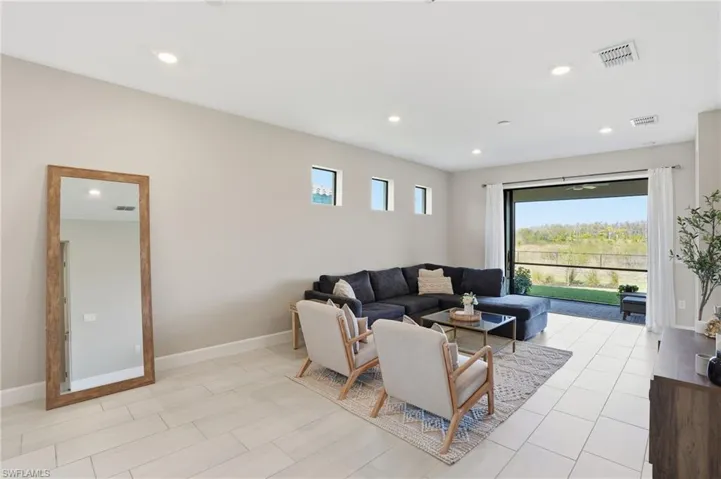Main living area off kitchen opens up to screened lanai with private preserve view.