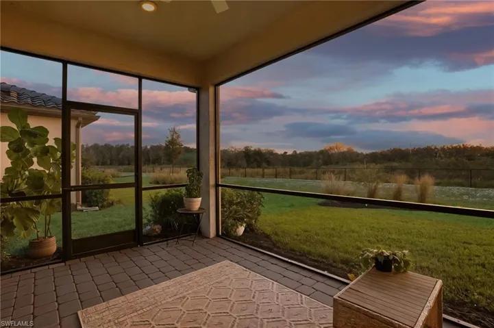 Semi-panoramic screened lanai overlooking private preserve area.
