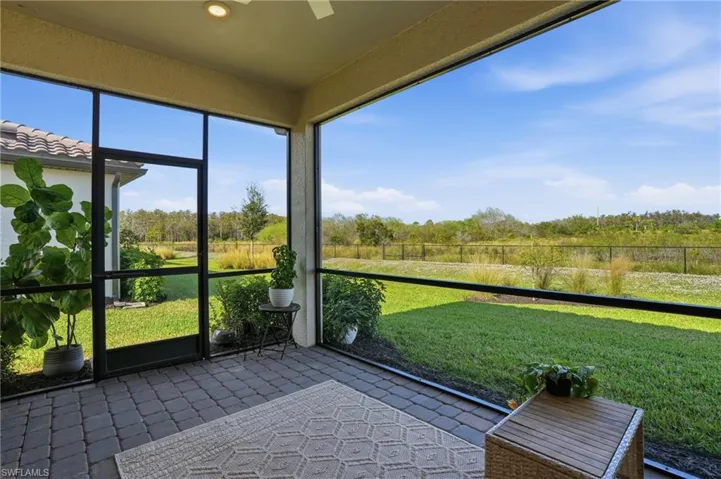 Semi-panoramic screened lanai overlooking private preserve area.