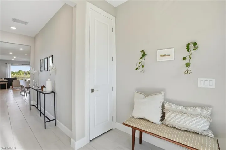 Foyer with bench seating and entry closet.