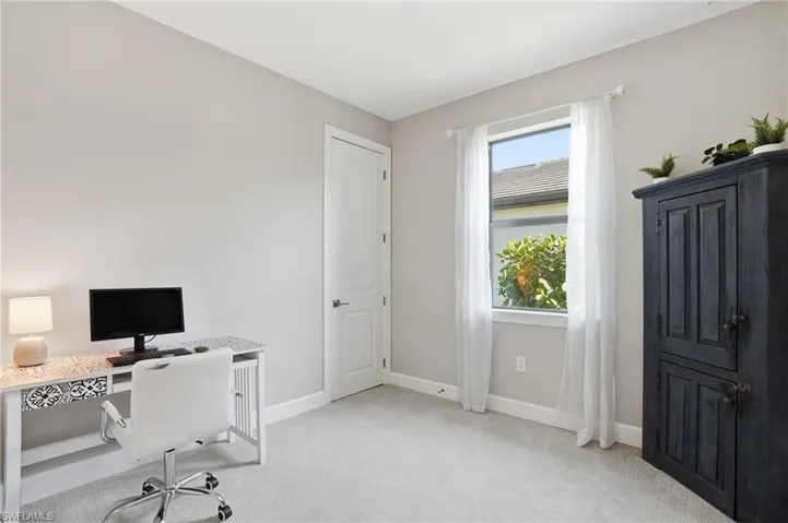Guest bedroom being utilized as an office space.