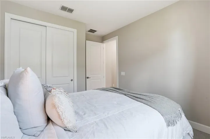 Large guest bedroom with plush carpeted floors.
