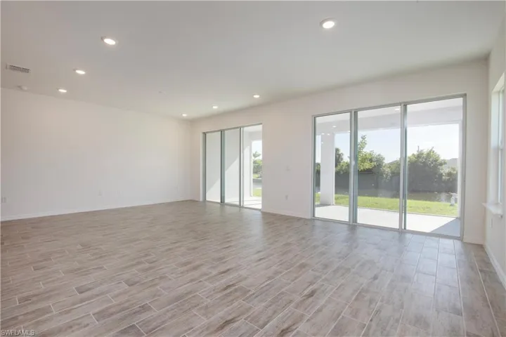 Empty room featuring wood tiled floors and recessed lighting