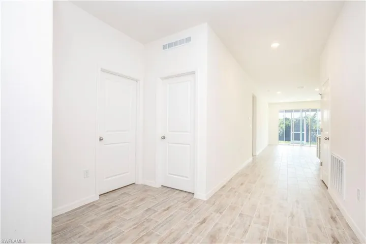 Corridor featuring wood tiled floors and recessed lighting