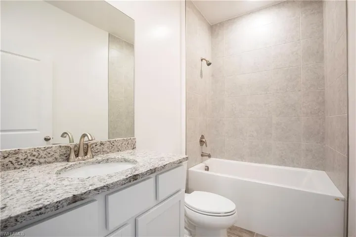 Bathroom featuring  shower combination and vanity
