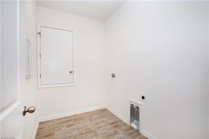 Laundry room featuring hookup for a washing machine, wood finish floors, and hookup for an electric dryer