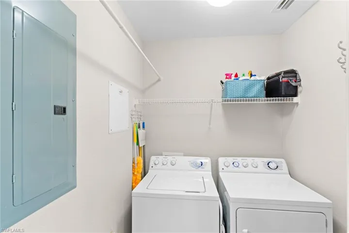 Laundry room with electric panel and independent washer and dryer