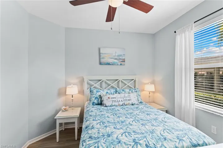 Bedroom featuring ceiling fan and dark wood-type flooring