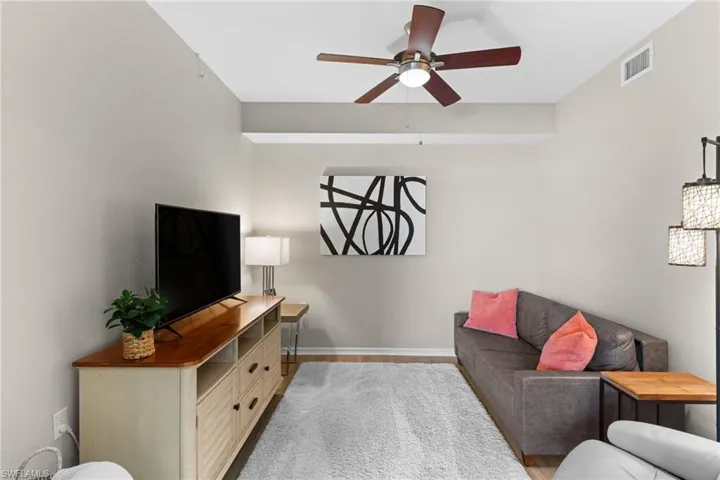 Living area with a ceiling fan and wood finished floors