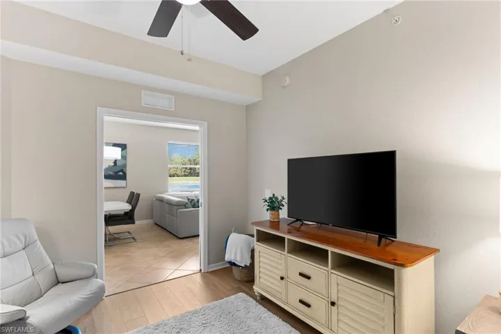 Living room with a ceiling fan and light wood finished floors